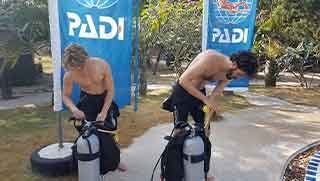 Open Water diver course divers setting up equipment by the swimming pool