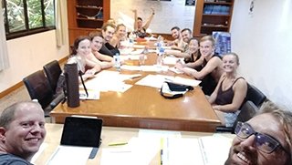 Padi Open Water divers smiling in the classroom while they completing their exams