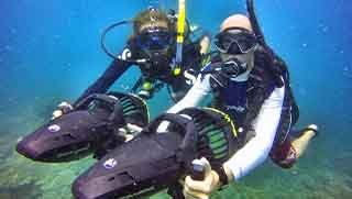PADI Advanced open water divers using a diver propulsion vehicle underwater