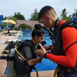 Reactivate Scuba Refresher Program divers buddy check by the side of the swimming pool