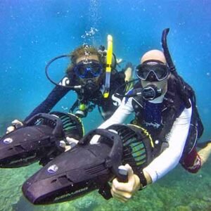 Diver Propulsion Vehicle Specialty divers underwater with dpv