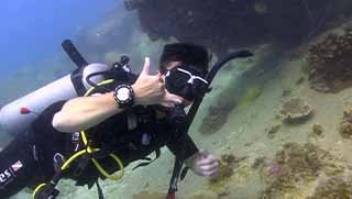 Underwater Navigation Specialty course diver show sign underwater at Koh Tao, Thailand.