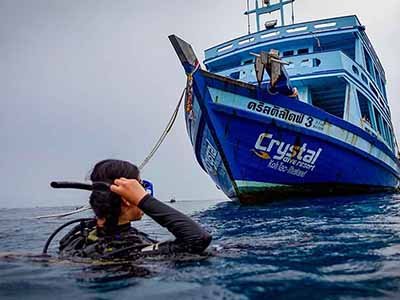 PADI Nitrox Diver course Crystal 3 dive boat and diver on surface