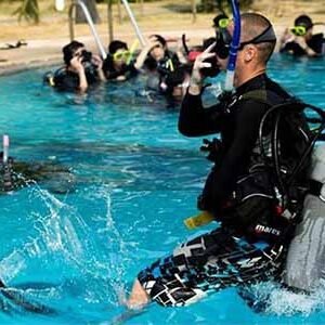 Open Water Course diver jump in swimming pool