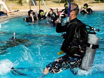 Open Water Course diver jump in swimming pool